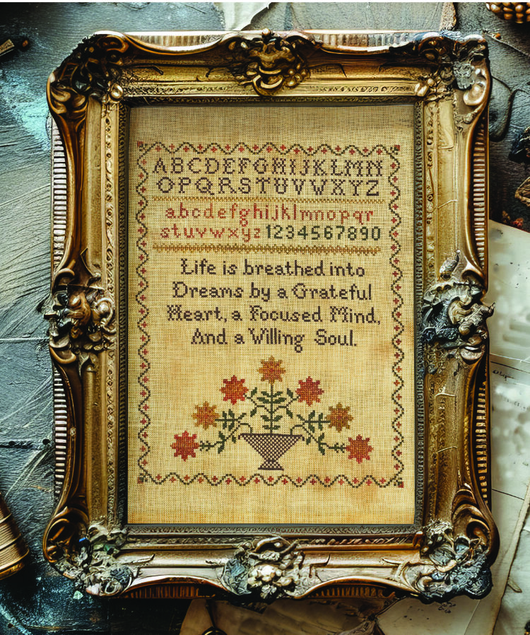 a photo of a framed cross stitch sampler