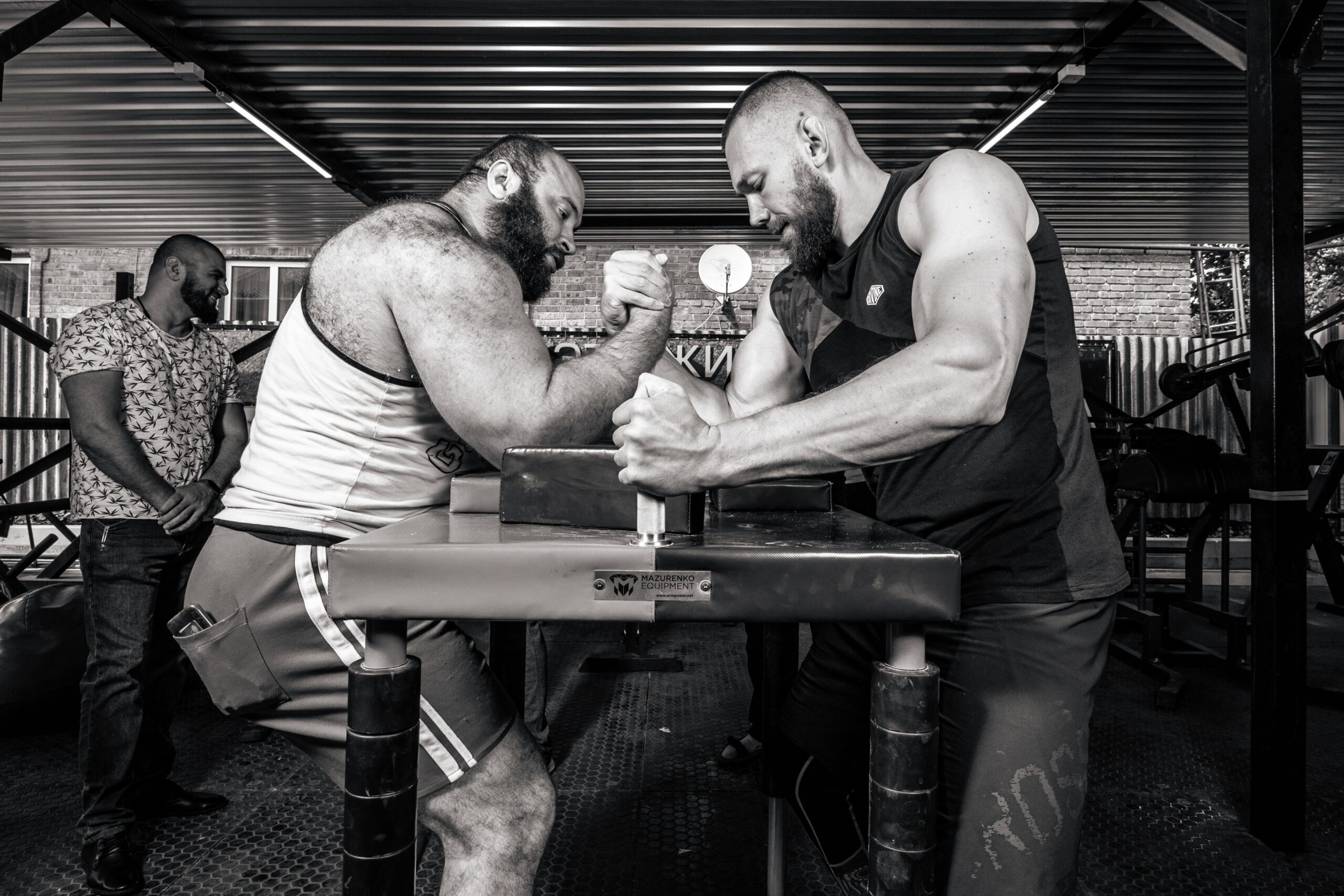 black and white photo of two men arm wrestling